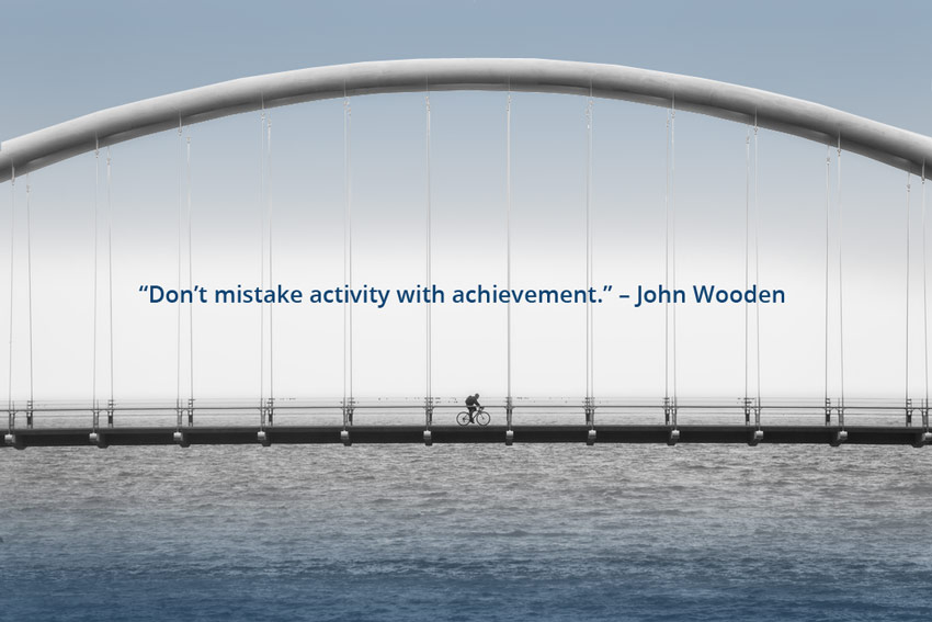 Dont-mistake activity with achievement, John Wooden Quote